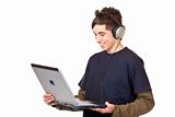 Teenager with headset makes internet mp3 music download at computer