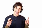 Male Teenager with headphones listening to music and sings happy