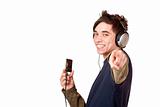 Teenager with headphones and mp3 player points with finger
