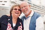 Senior Couple On Shore in Front of Cruise Ship While on Vacation.