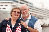 Senior Couple On Shore in Front of Cruise Ship While on Vacation.