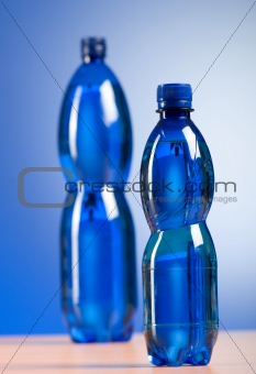 Bottle of water against colorful gradient background