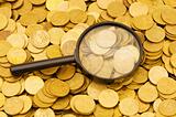 Magnifying glass and lots of gold coins