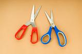 Colorful scissors on the color paper background