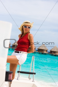 Lady stands abovedeck white yacht