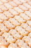 Shaped browned crisp biscuits as tile background