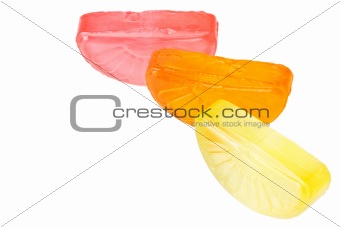 Fruit drop lemon, orange and grapefruit sections isolated on white
