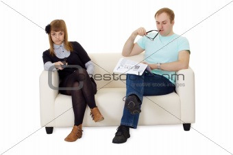 Father reading newspaper, daughter watching TV