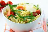 pasta salad with tomatoes and arugula