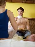 young couple having breakfast on bed