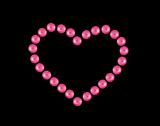 Heart from pink beads isolated on black background