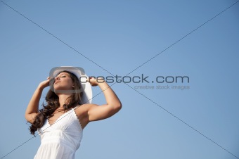 Girl in the blue sky with hat