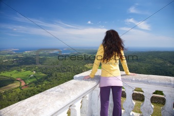 woman yellow pullover watching ocean