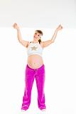 Smiling beautiful pregnant woman holding blank billboard over her head
