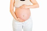 Pregnant woman holding her belly isolated on white. Close-up.
