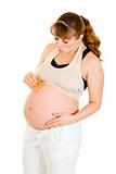 Pregnant woman holding  baby dummy near belly
