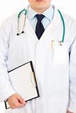 Medical doctor with stethoscope holding  clipboard.  Close-up.
