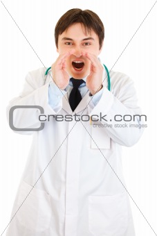 Angry doctor shouting through  megaphone shaped  hands
