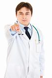 Confident young medical doctor pointing finger at you
