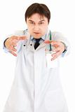Angry  medical doctor with stethoscope. Focus on hands.
