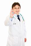 Smiling medical doctor showing ok gesture
