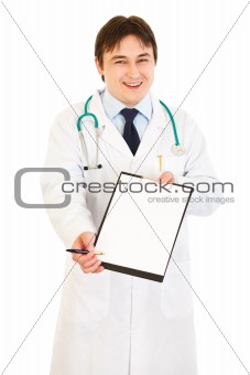 Smiling young  doctor  with documents and pen for signing
