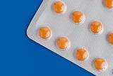 Close-up of a pack of orange pills 