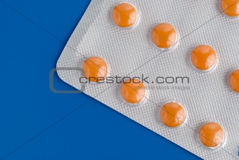 Close-up of a pack of orange pills 