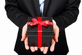 Businessman holding a gift package in hand
