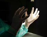 Surgeon holding up hands in protective gloves