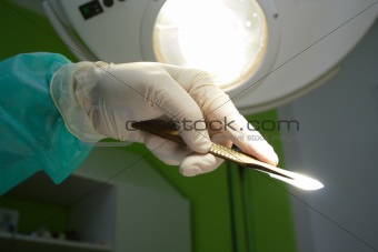 scalpel in surgeon's hand