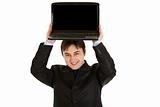 Pleased modern businessman holding laptop with blank screen over his head
