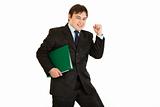 Pleased modern businessman holding folder with documents
