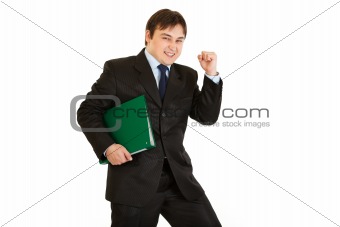Pleased modern businessman holding folder with documents
