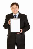 Smiling modern businessman holding blank clipboard in hands
