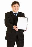 Smiling modern businessman with documents and pen for signing
