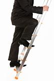 Businessman climbing upwards upon ladder.  Close-up.
