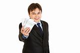 Smiling modern businessman holding money in his hand
