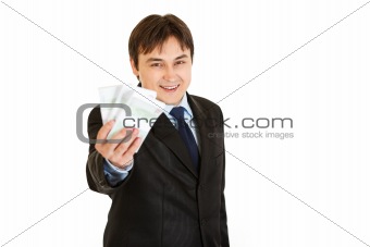 Smiling modern businessman holding money in his hand
