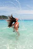 lovely girl in sea water creates a splash