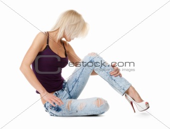 relaxing blonde in jeans on white