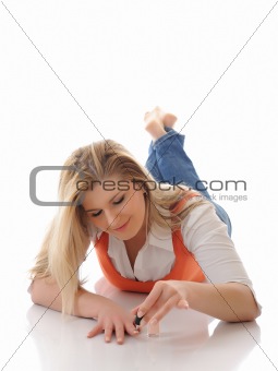Beautiful girl applying nail polish making manicure