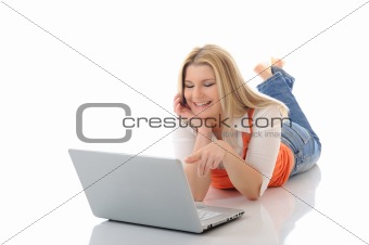 Young pretty girl networking on laptop computer in internet
