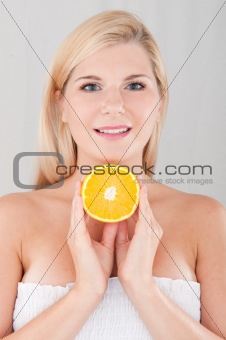 pretty woman with an orange fruit