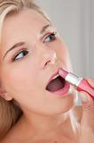 pretty woman applying lipstick make-up