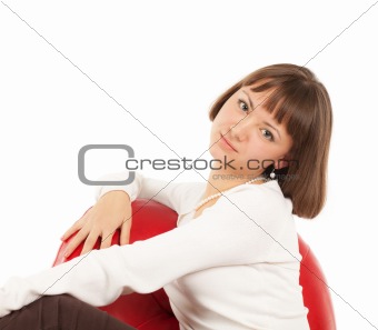 Pretty blond girl in red leather chair