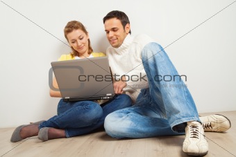 Smiling couple with laptop computer