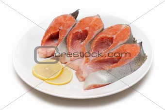Red fish bit with lemon on plate