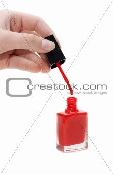 Hand with tassel and red varnish for nail