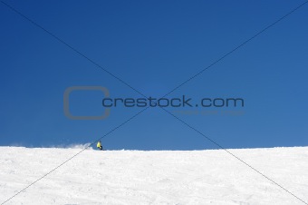 One person skiing in vast slopes of european alps.
